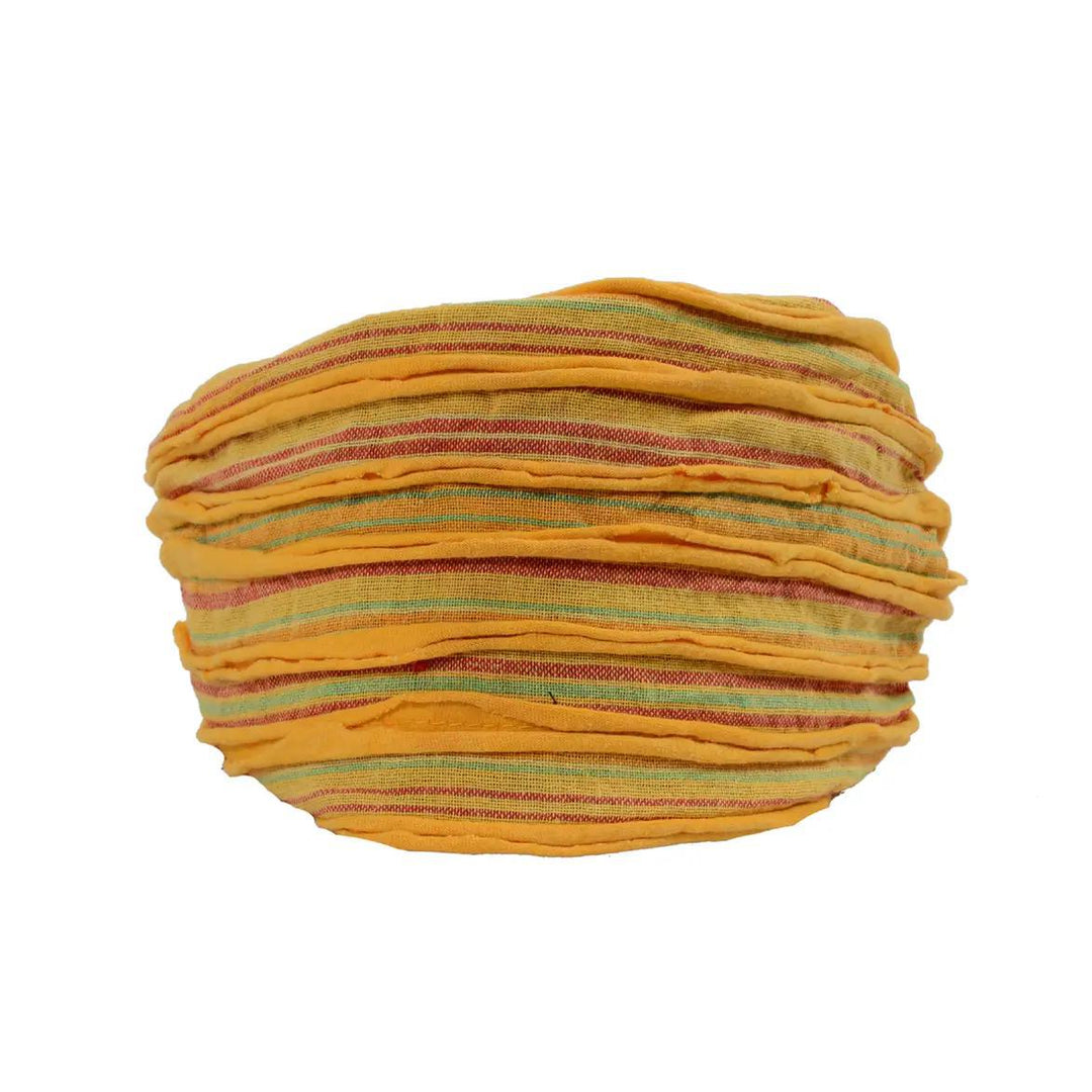 An orange headband with a razor cut style, featuring shades of green and brown.