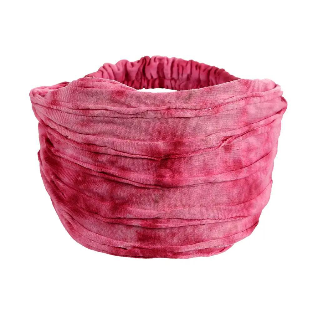 A pink razor cut headband on a white background.