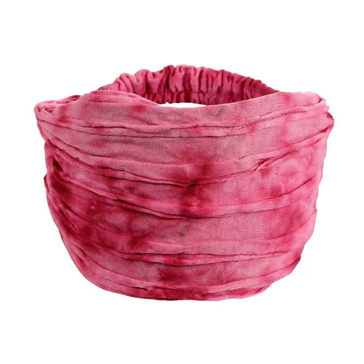 A pink razor cut headband on a white background.
