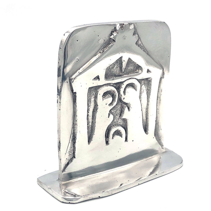 A polished aluminum metal manger nativity shown on a plain white background.