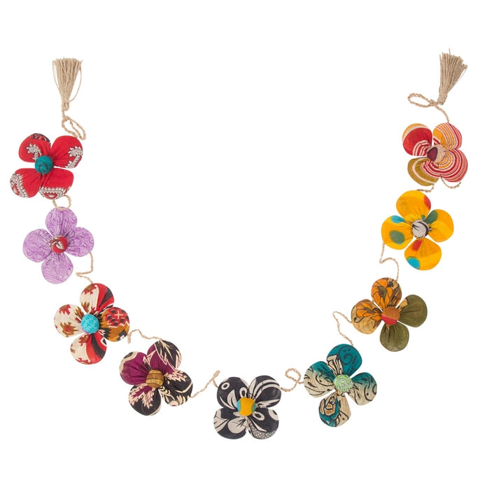 Colorful flower-shaped garland decorations with tassels on a white background
