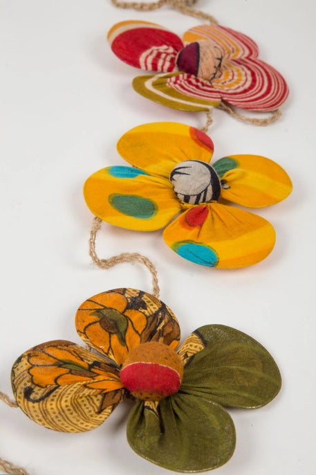 Colorful recycled sari flower-shaped garland on a white background