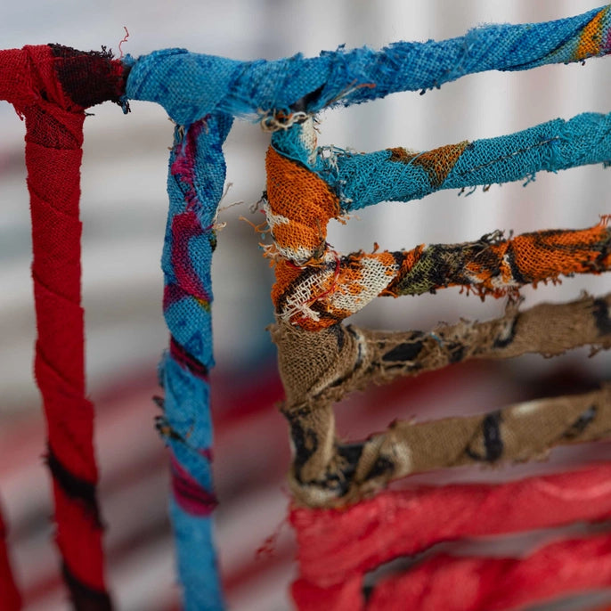 Close-up of colorful fabric wire basket on a blurred background