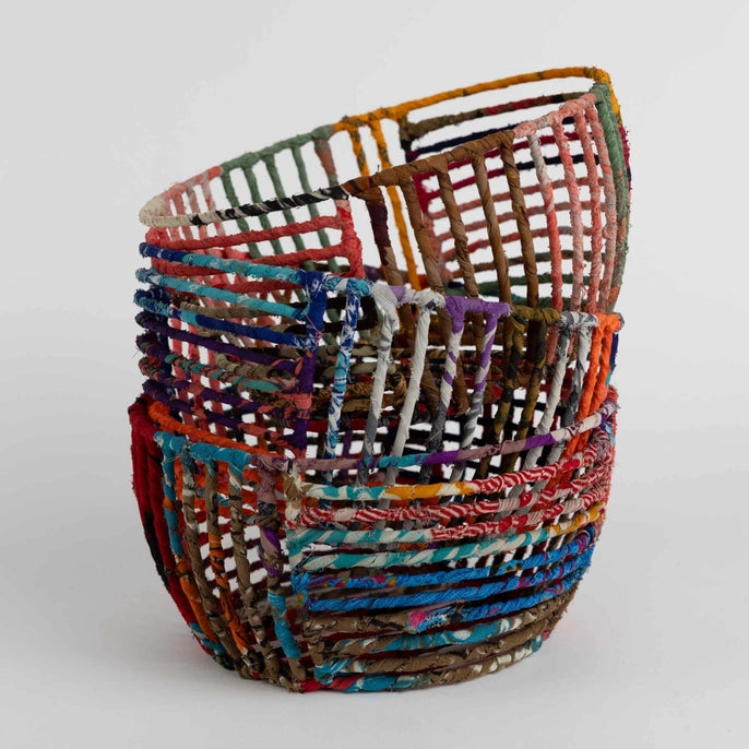 Stack of colorful wire baskets on a white background