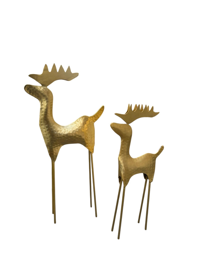 Two gold-toned deer figurines with textured metallic finishes and long thin legs, shown on a plain white background.