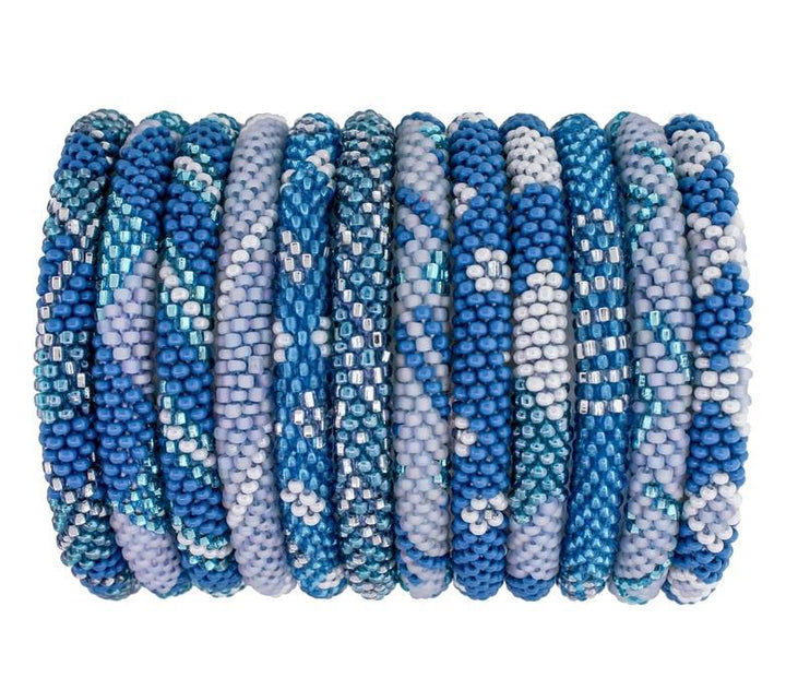 Beaded roll-on bracelets with blue patterns and shades displayed on a roll.