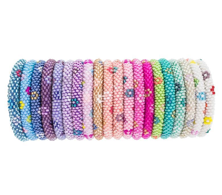 A multicolored bracelet made with glass beads and hand-dyed cotton thread, displayed on a roll.