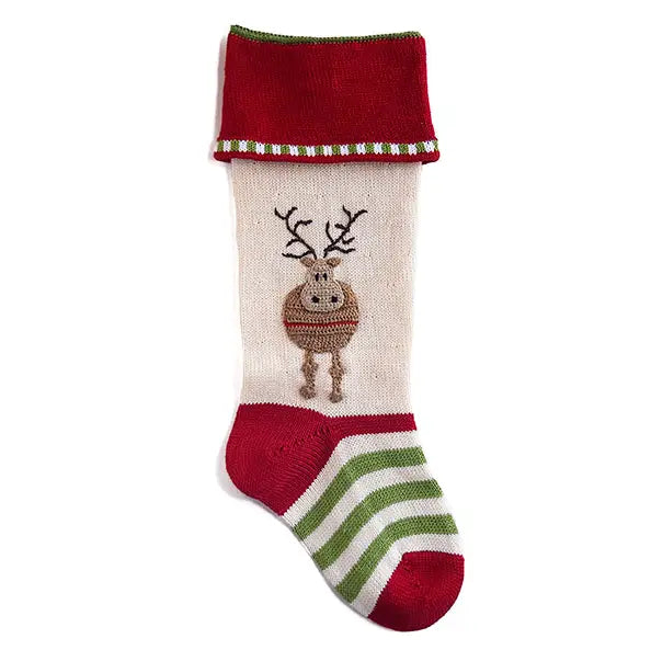 A festive Christmas stocking with a cream body, a red cuff trimmed with green and white stripes, a green and white striped foot, and an embroidered reindeer on the front.