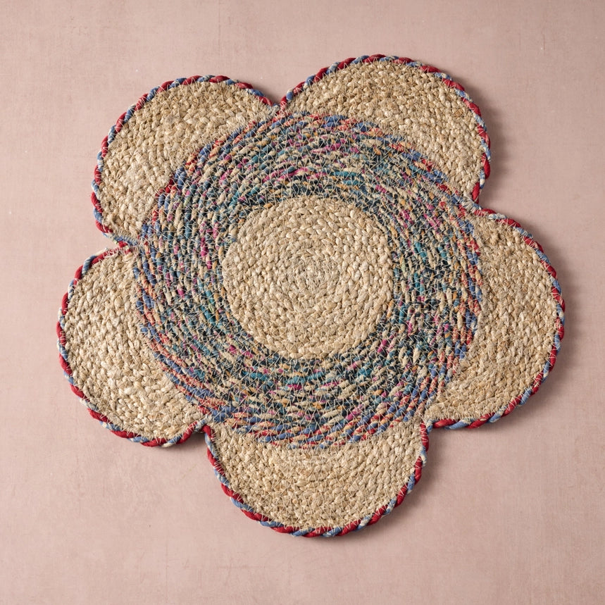Set of woven placemats with a multicolor pattern on a pink background