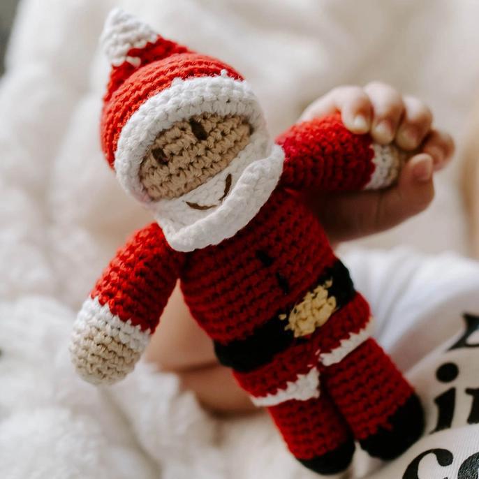 Hand knitted baby rattle in the shape of a jolly Santa Claus.