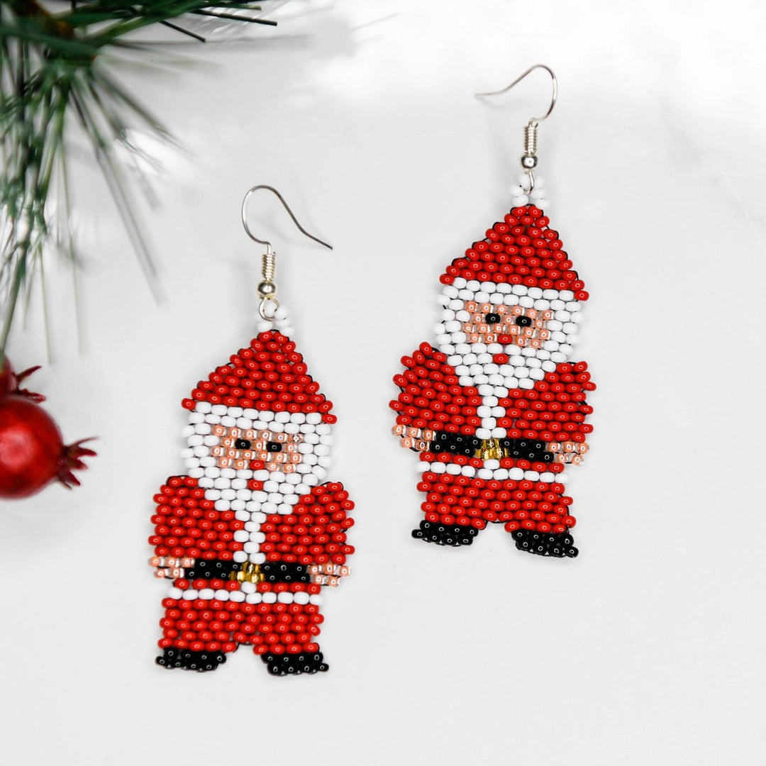 Beaded Santa Claus earrings on a white background with a Christmas tree branch.