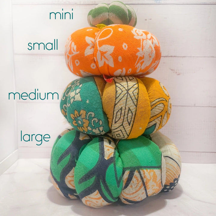 large, medium, small, and mini saree pumpkins stacks on top of each other