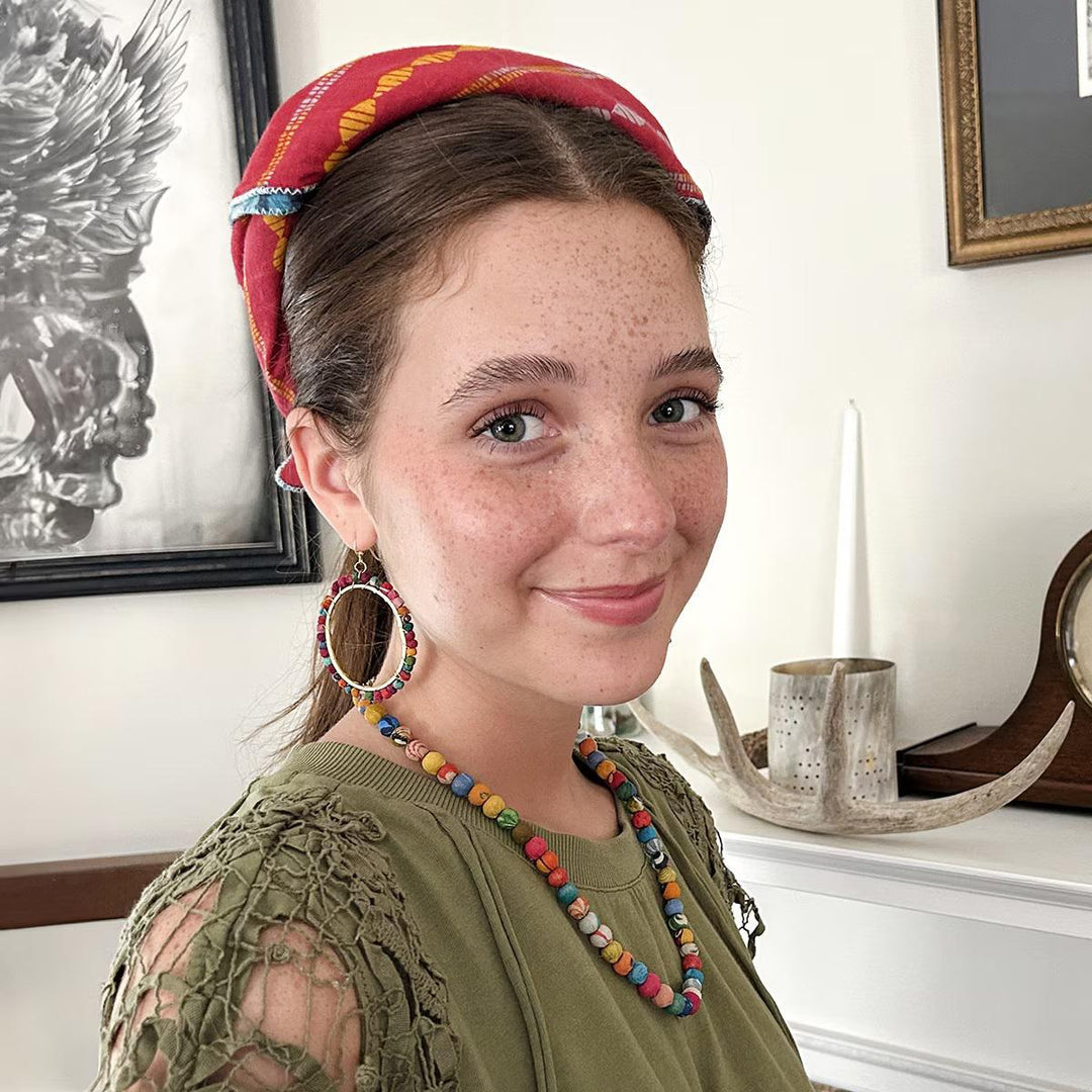 Woman wearing a colorful bandana indoors