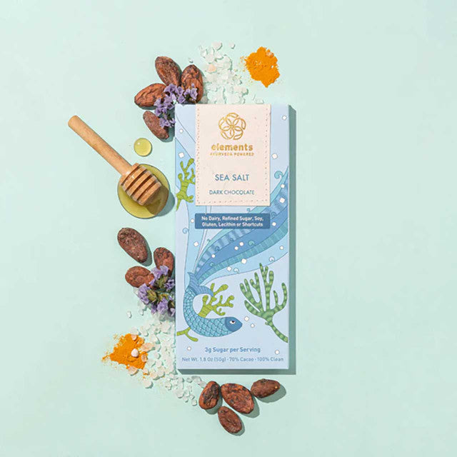 Sea Salt Dark Chocolate packaging with natural elements on a light blue background