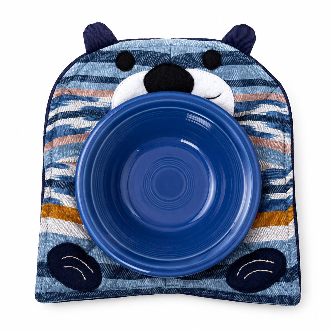Blue ceramic bowl with a striped animal-shaped holder on a white background