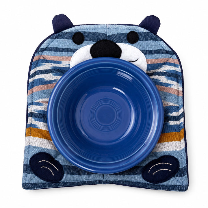 Blue ceramic bowl with a striped animal-shaped holder on a white background