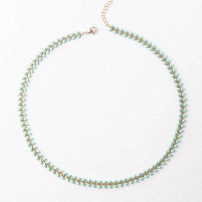 An adjustable gold-plated stainless steel necklace with sea foam green beads on a white background.