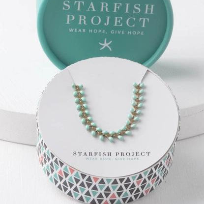 Starfish Project necklace in a branded box on a white background