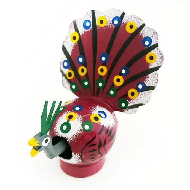 Small figurine resembling a peacock made from a gourd in Mexico.