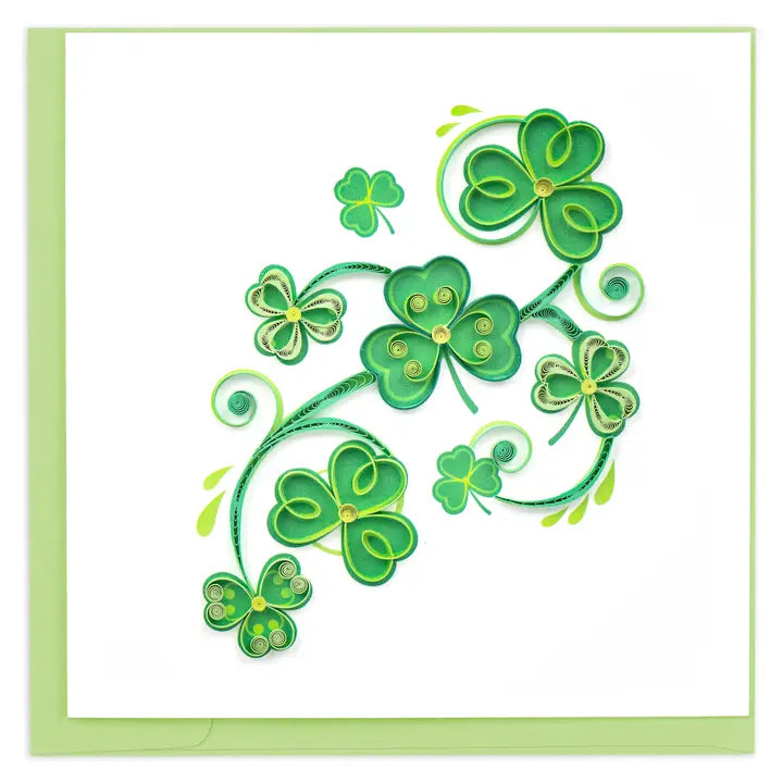 Decorative quilled card with green four-leaf clover design on a white background