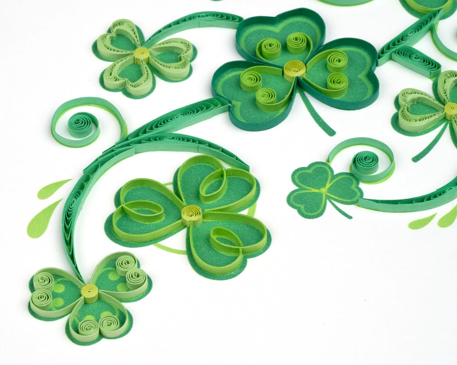 Quilled green shamrocks on a white background