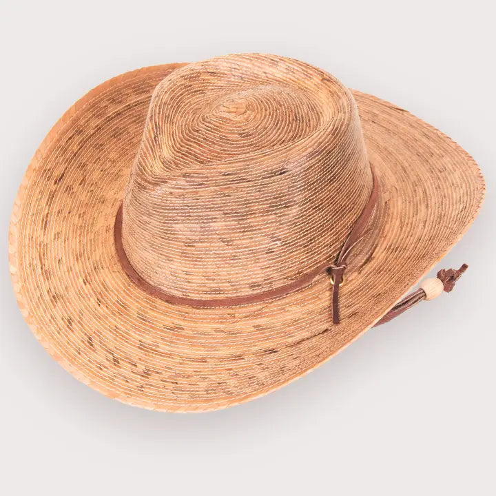 Straw hat with a wide brim on a light gray background