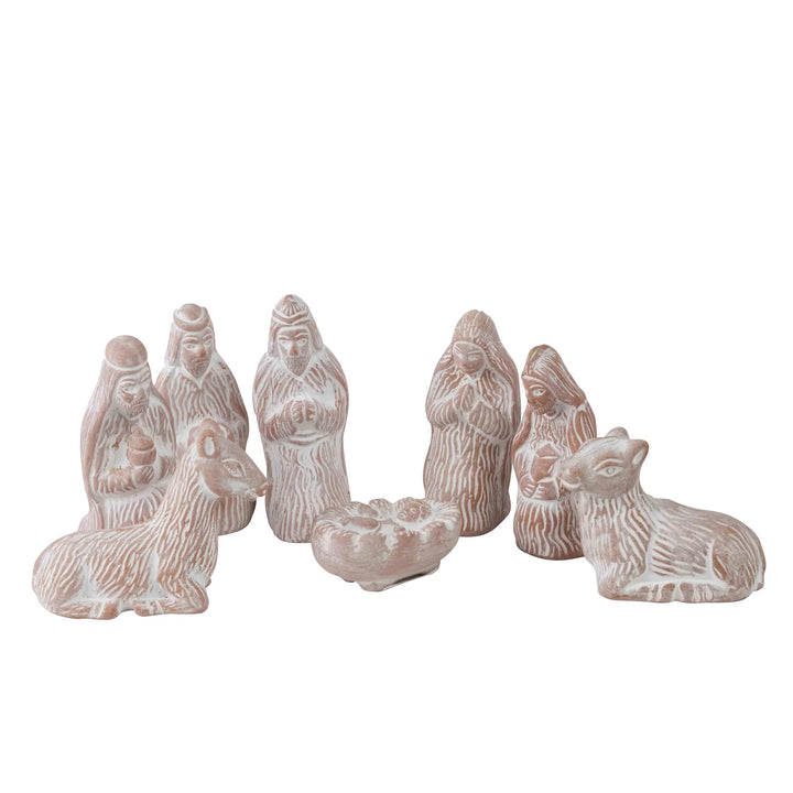 Set of white ceramic nativity scene figures on a white background