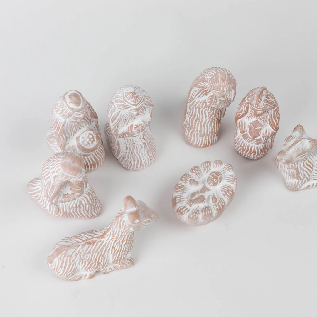 Collection of small ceramic animal figurines on a light gray background