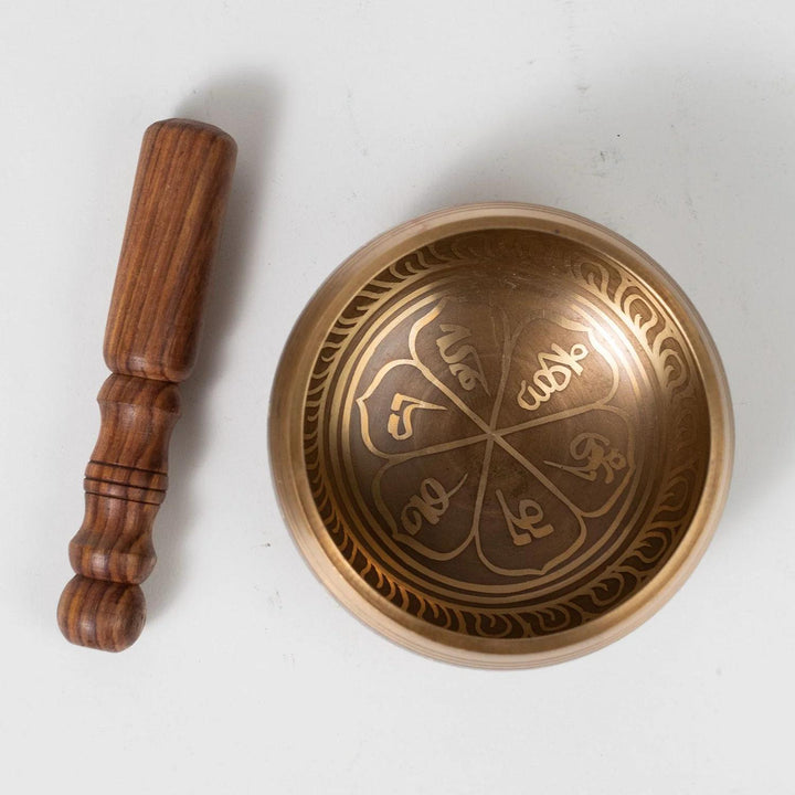 singing bowl with striker on a white background