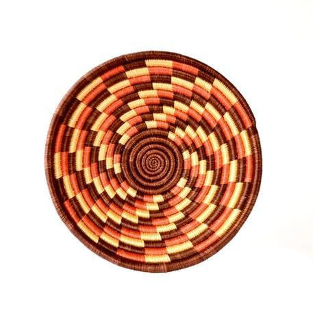 Hand-crafted basket with beautiful autumn colors, such as red, orange, and beige. 