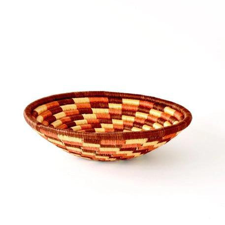 Hand-crafted basket with beautiful autumn colors, such as red, orange, and beige. 