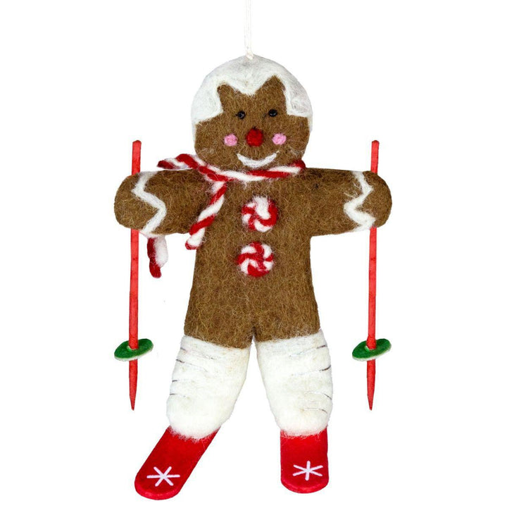 Gingerbread man ornament with skis on a white background