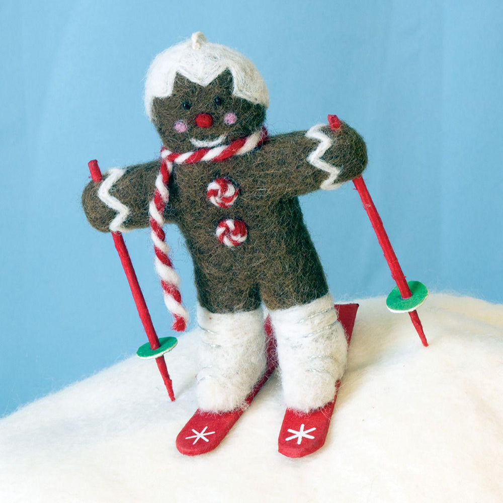 Gingerbread man ornament skiing on a blue background
