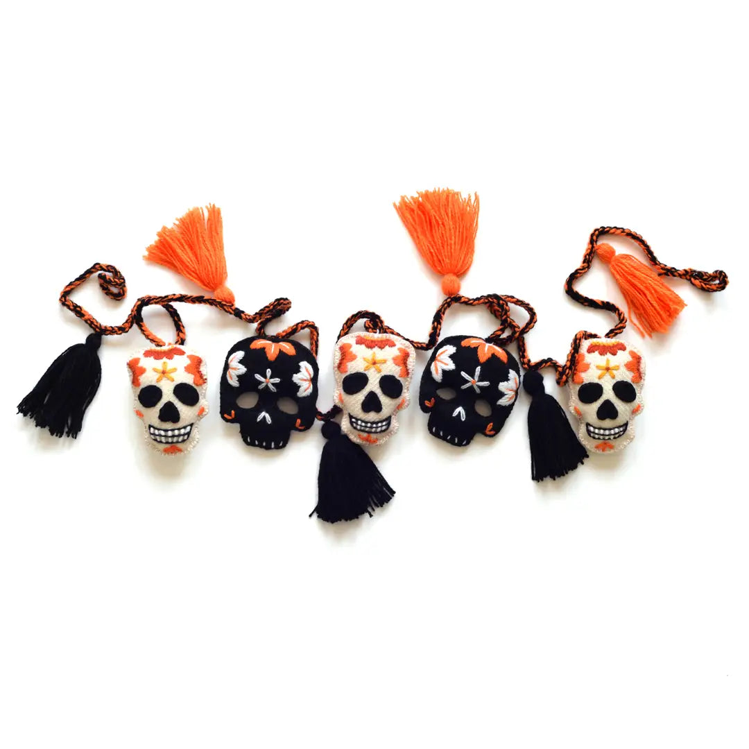 Decorative skull garland with tassels on a white background