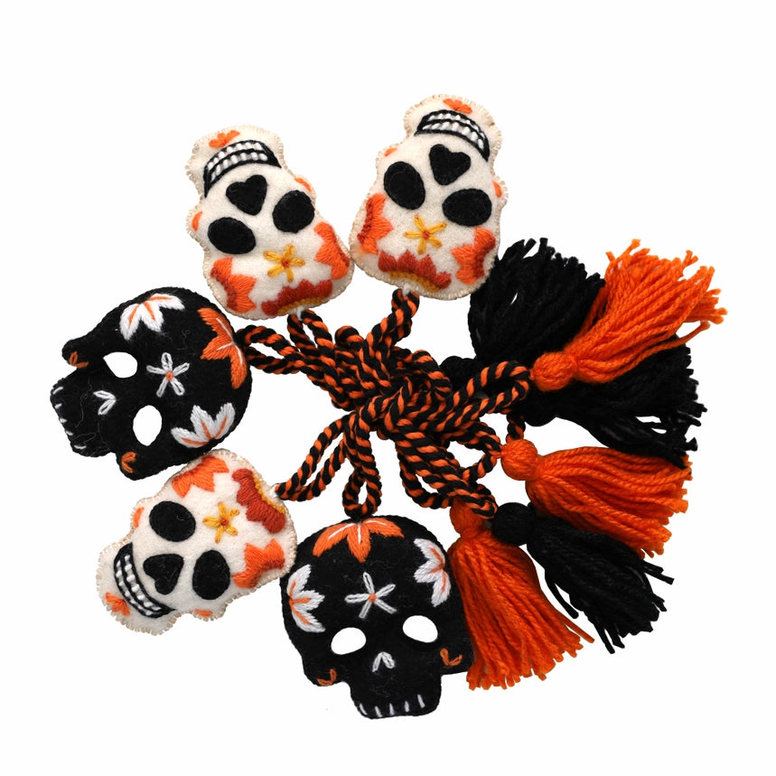 garland with skull designs and a rope on a white background