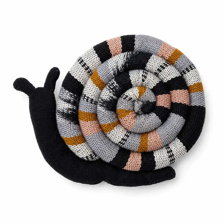 A knitted snail mug warmer with a black body and antennae and a spiral shell featuring a striped pattern of black, gray, white, peach, and mustard yellow, shown on a plain white background.