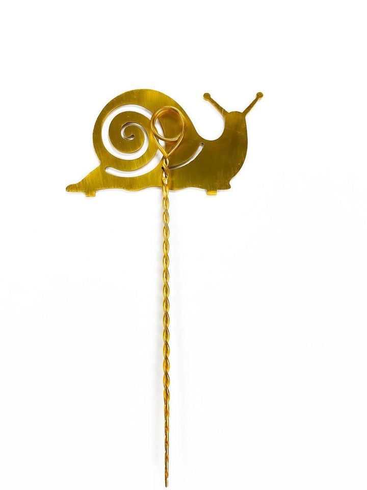 Gold snail-shaped decorative plant stake on a white background