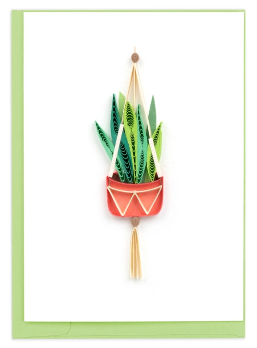 Decorative greeting card with plant hanging with green leaves, red pot, and tassel on a white background