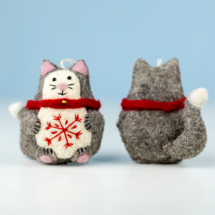 Two felt cat ornaments with red scarves and snowflake designs on a light blue background.