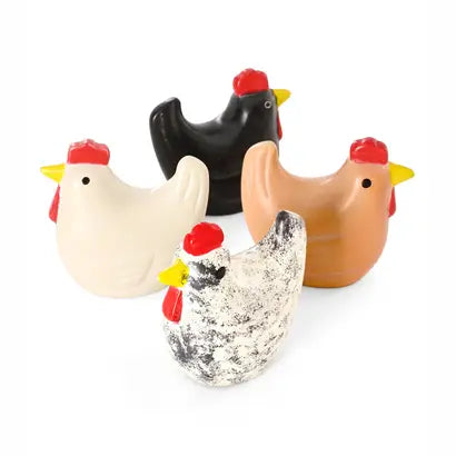 Four soapstone chicken figurines in different colors and patterns, including black, tan, cream, and mottled gray, each with red combs/wattle and yellow beaks, arranged on a white background.