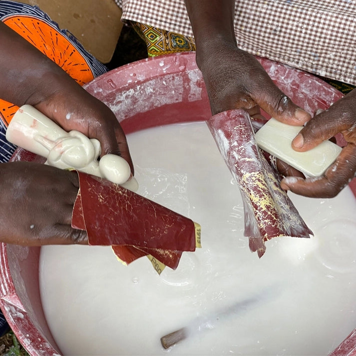 Person preparing sanding soapstone on a white surface