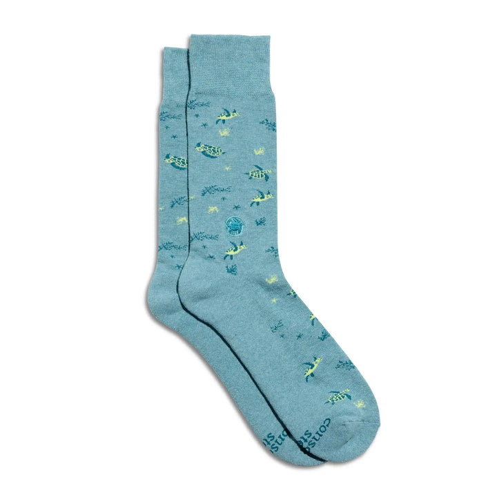 Blue socks with sea turtle pattern on a white background