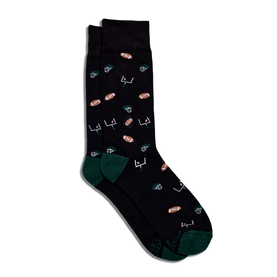 Black sock with colorful football themed designs on a white background