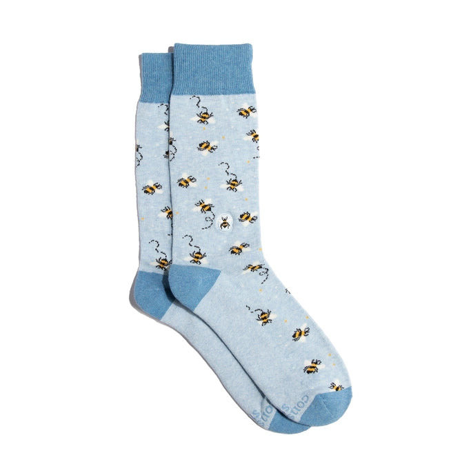 Light blue socks with bee pattern on a white background