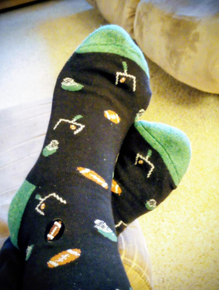 Black socks with green tops and colorful patterns