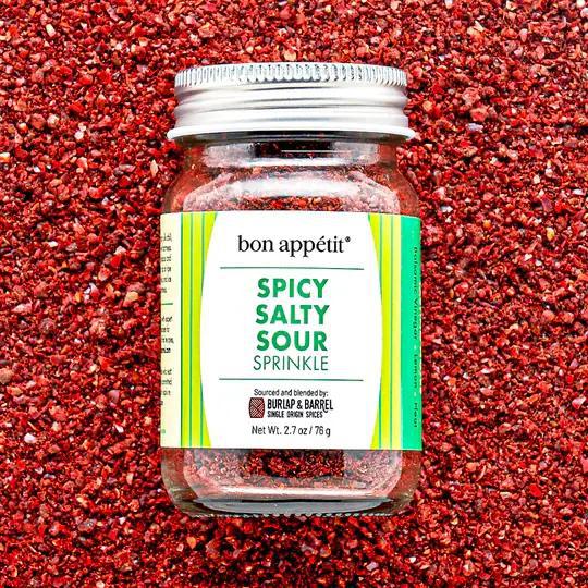 Jar of bon appetit Spicy Salty Sour sprinkle on a red spice background