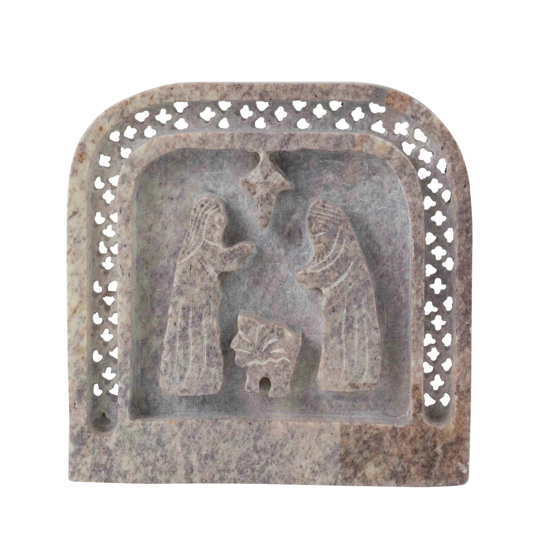 Decorative stone plaque with a relief of a nativity scene on a white background