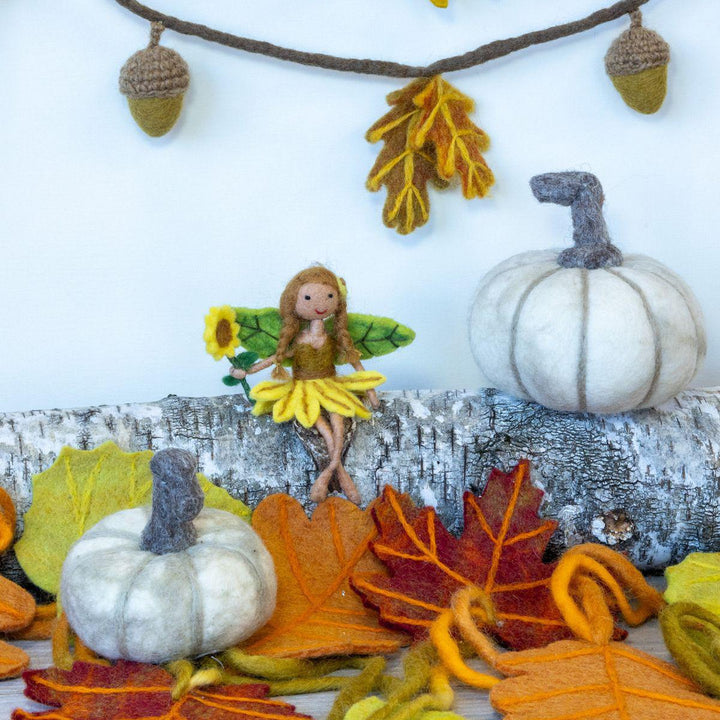 Fairy ornament with pumpkins and autumn leaves on a white background