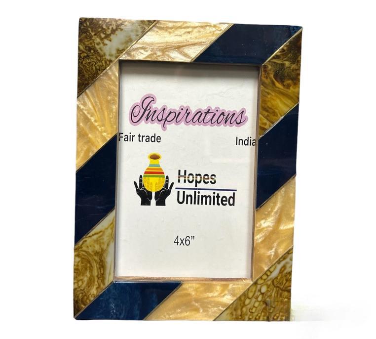 A decorative picture frame with a blue and gold design, labeled 'Inspirations' and 'Hopes Unlimited', indicating fair trade and handmade in India.