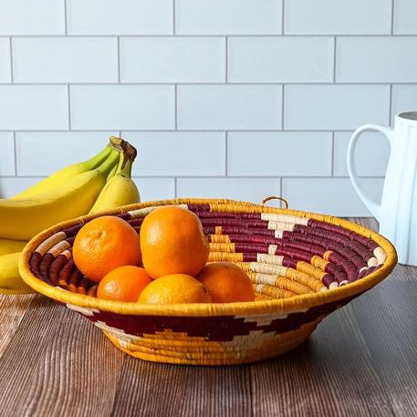 Beautiful coil basket in autumn colors, such as burgundy, orange, and tan. 